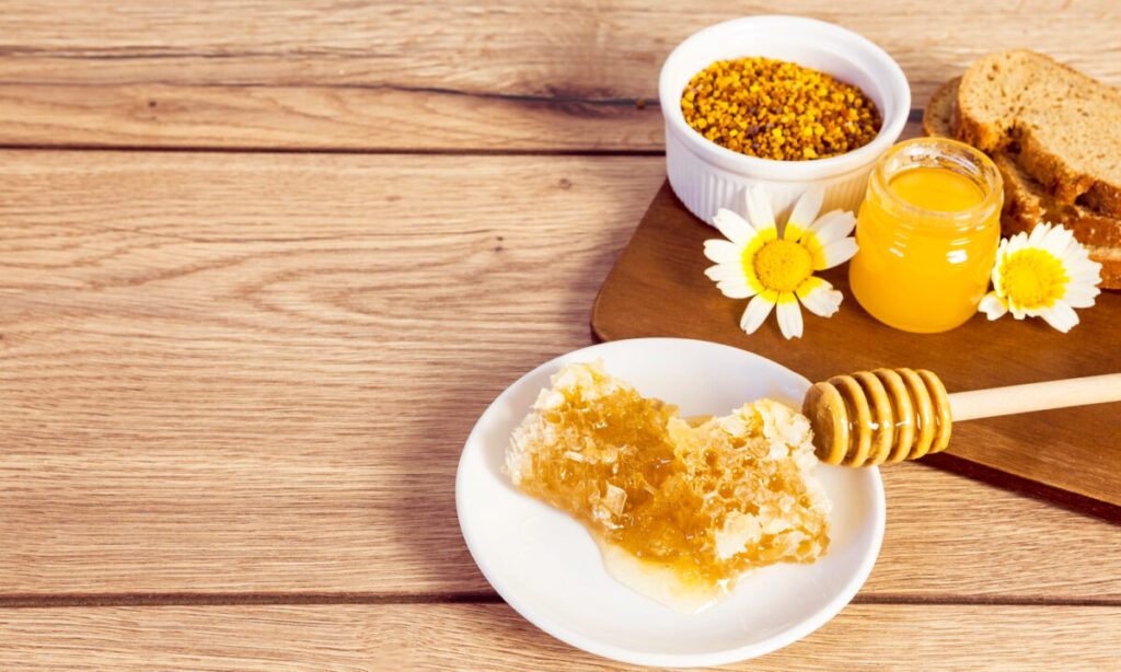 honeycomb bee pollen honey bread slice wooden surface — Včelaříme!